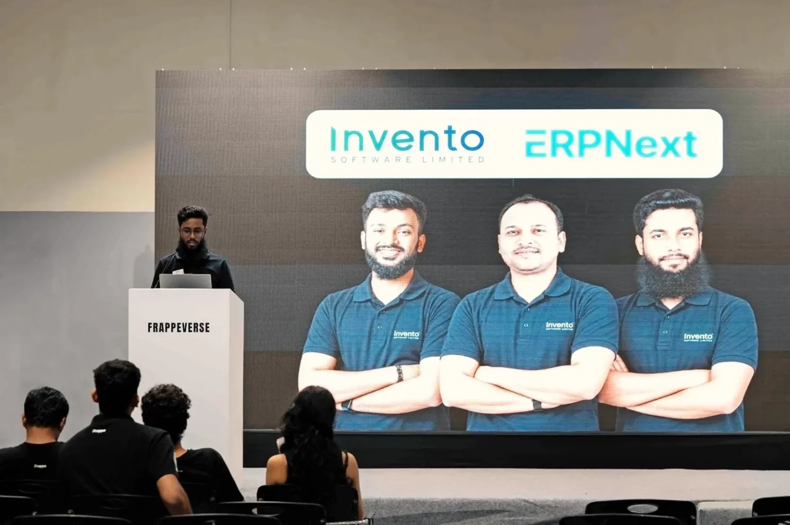 Invento presenting on the Frappeverse Mumbai 2026 stage, with the Invento and ERPNext title slide behind the podium