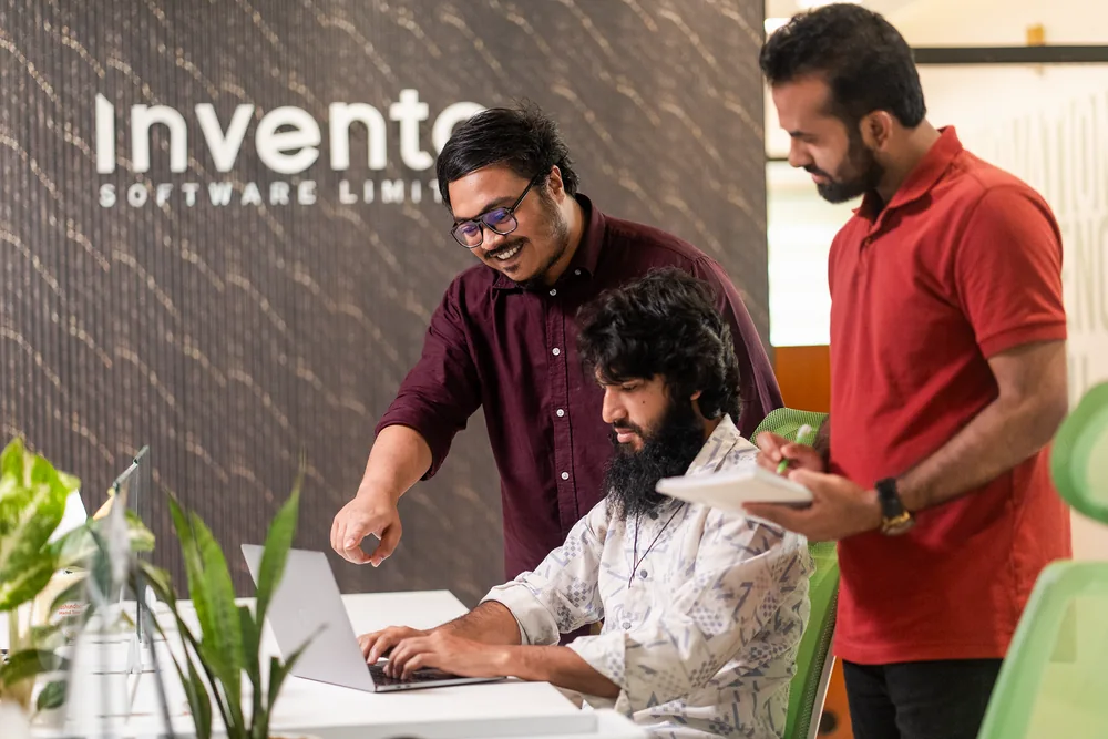 Invento team reviewing work together
